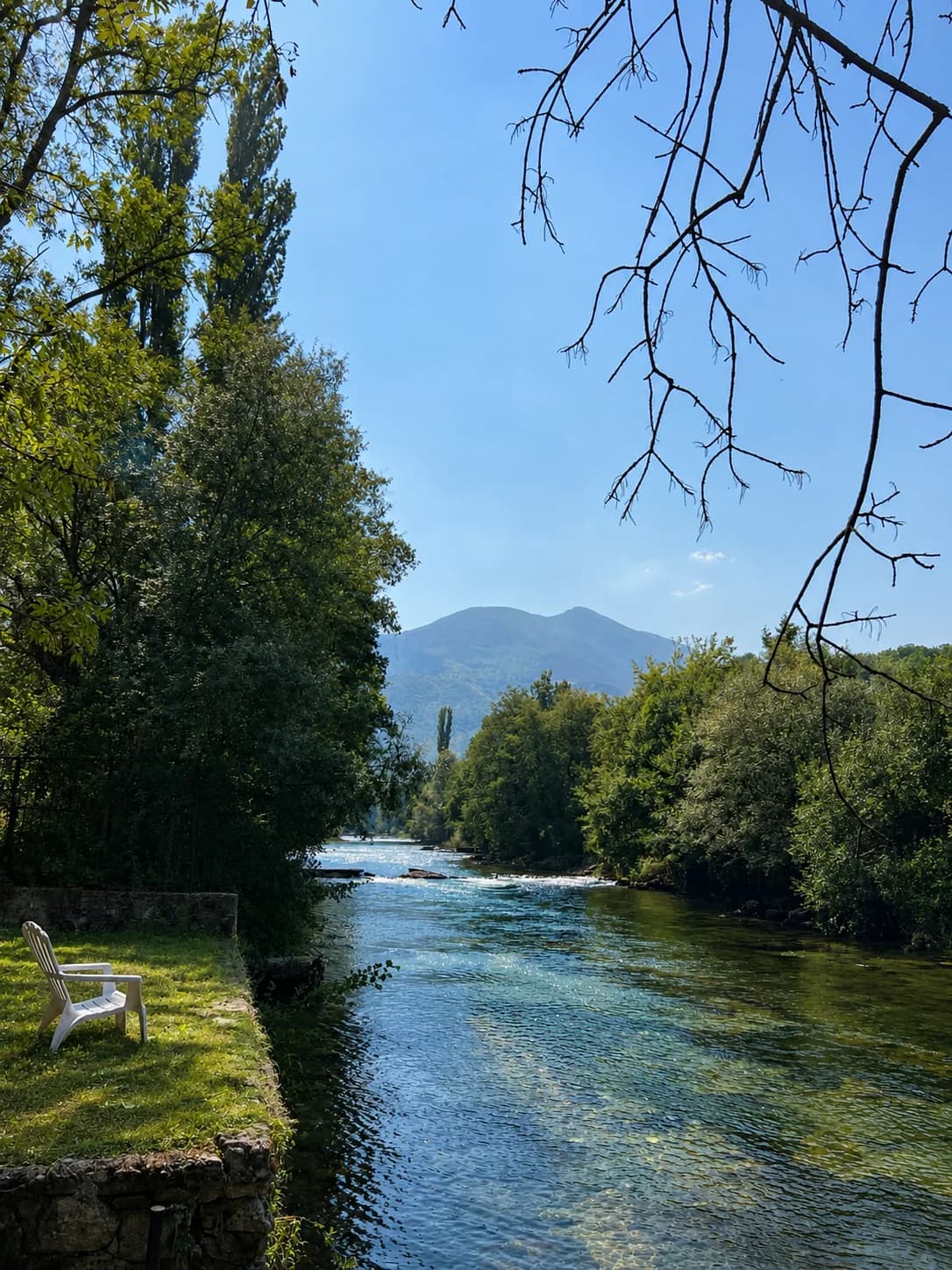 River beside the villa, surrounded by trees