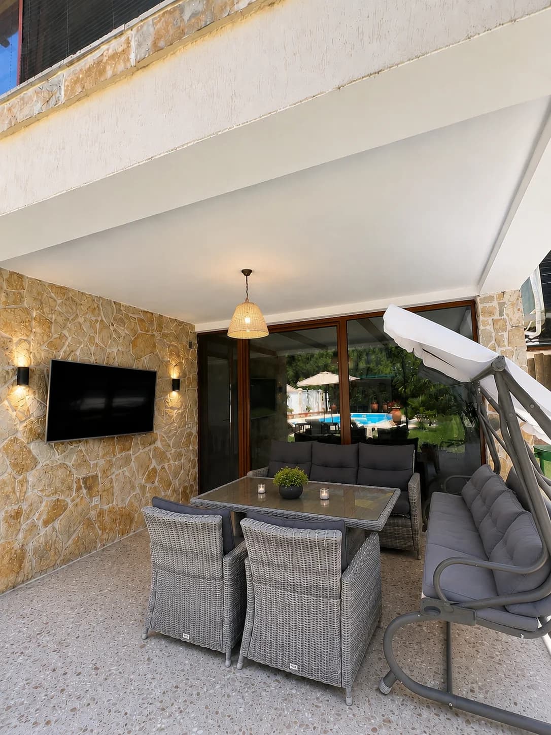 Covered terrace with dining table and seating